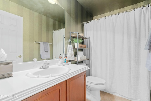 bathroom featuring tile patterned flooring, vanity, and toilet