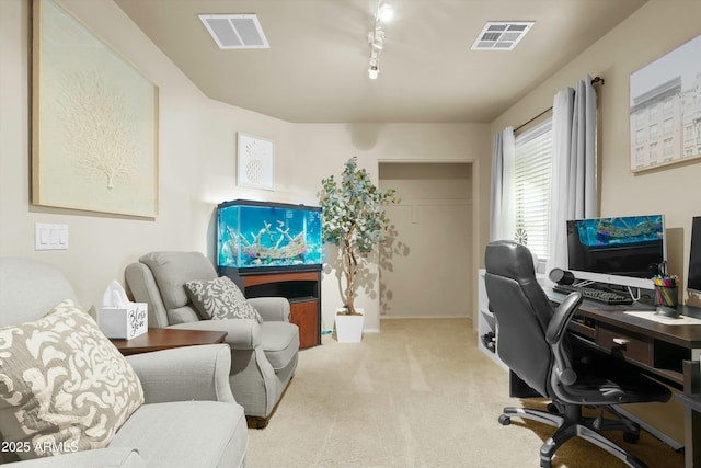 carpeted office featuring rail lighting