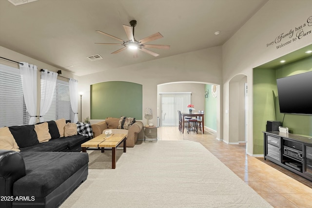 tiled living room featuring vaulted ceiling and ceiling fan