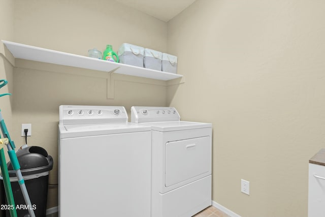 laundry area featuring washing machine and clothes dryer