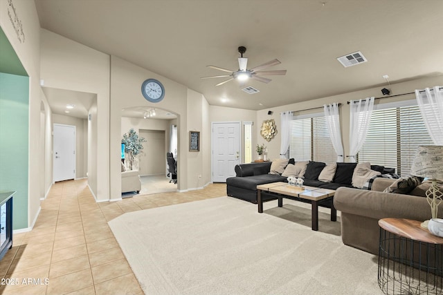 living room with light tile patterned floors, vaulted ceiling, and ceiling fan