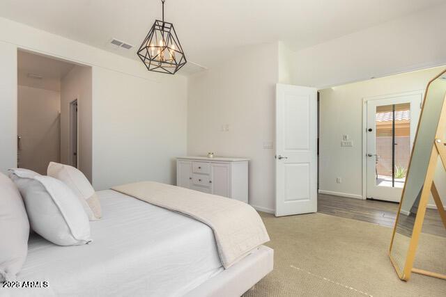 bedroom with light colored carpet, baseboards, and visible vents