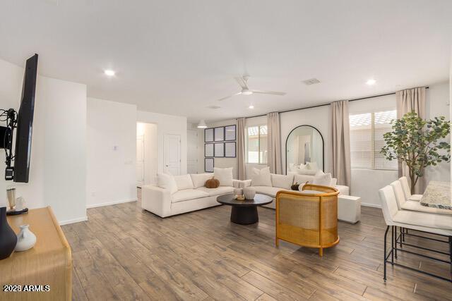 living room with recessed lighting, baseboards, ceiling fan, and wood finished floors