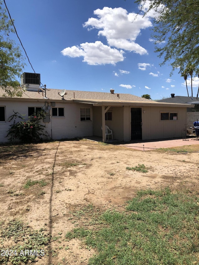 rear view of property with central AC unit and a patio area