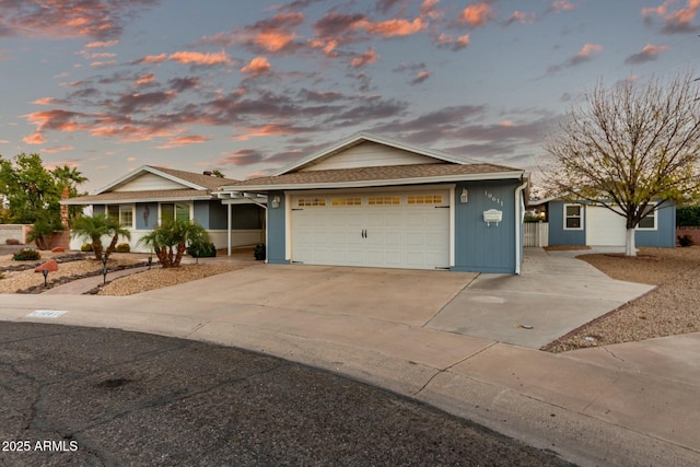 view of front of house with a garage and a storage shed