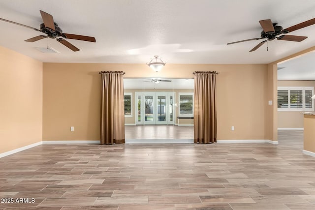 spare room with plenty of natural light and french doors