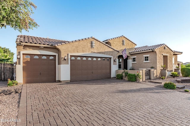 mediterranean / spanish house with a garage