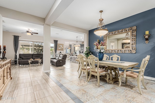 dining space featuring ceiling fan and beamed ceiling