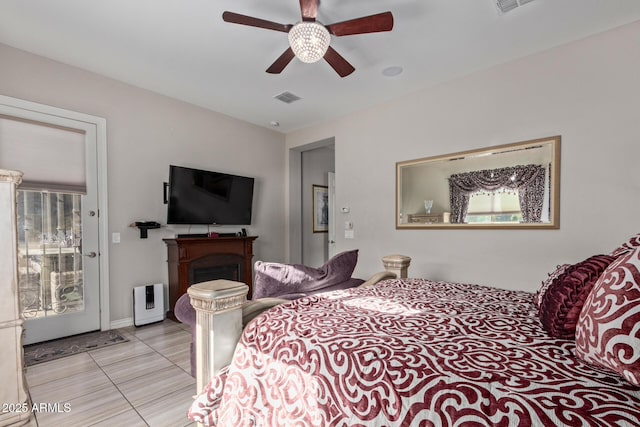 bedroom with ceiling fan and light tile patterned floors