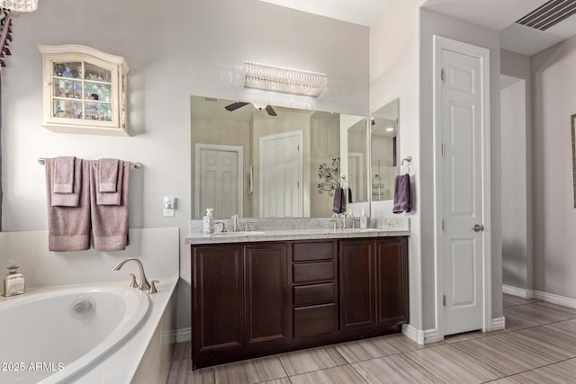 bathroom featuring vanity, ceiling fan, and a tub