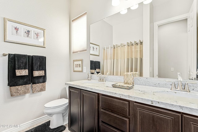 bathroom featuring toilet and vanity