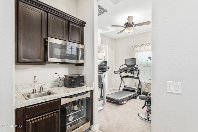 exercise area featuring sink, carpet floors, wine cooler, and ceiling fan