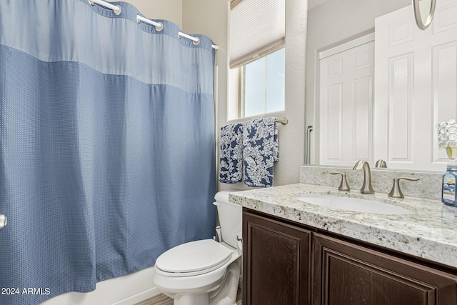 full bathroom with vanity, toilet, and shower / tub combo with curtain