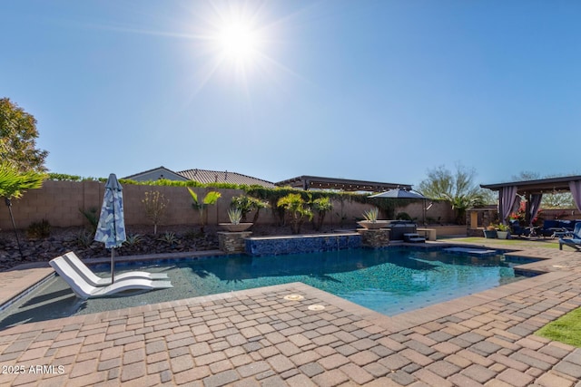 view of swimming pool featuring a patio area and a jacuzzi