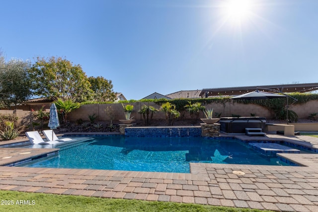 view of pool with a hot tub