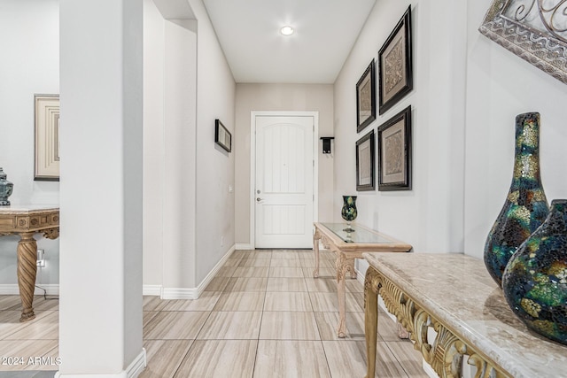 hall featuring light tile patterned flooring