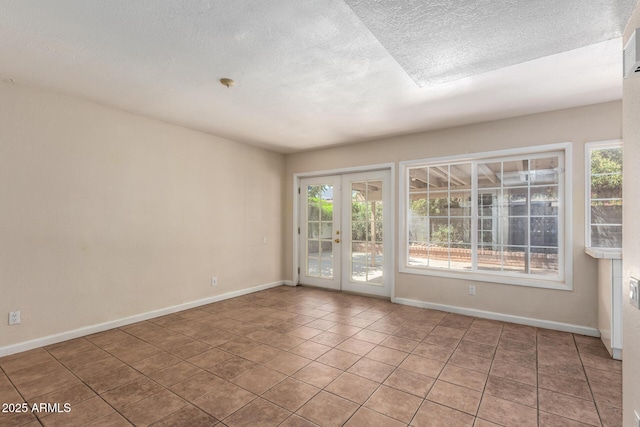 966 E Driftwood Dr, Tempe, AZ 85283 - tiled spare room featuring healthy amount of natural light, a textured ceiling, baseboards, and french doors