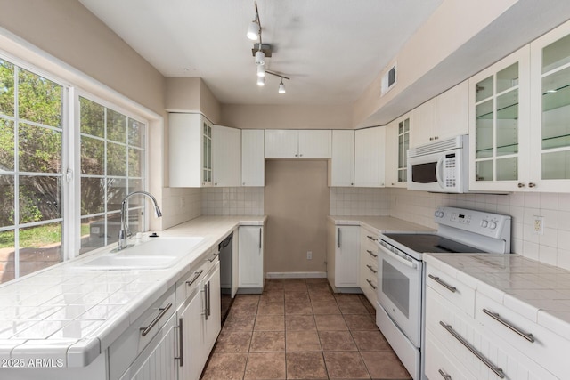 966 E Driftwood Dr, Tempe, AZ 85283 - kitchen with white appliances, a sink, tile countertops, and backsplash