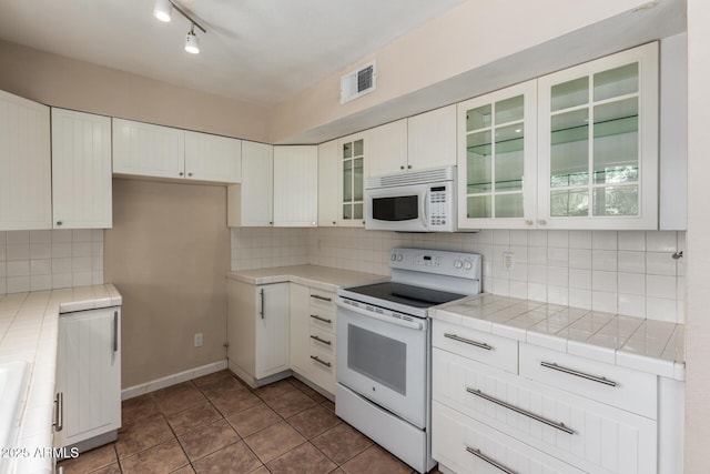 966 E Driftwood Dr, Tempe, AZ 85283 - kitchen with white appliances, white cabinetry, tile countertops, tasteful backsplash, and tile patterned floors