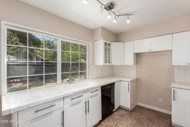 966 E Driftwood Dr, Tempe, AZ 85283 - kitchen with a sink, dishwasher, tasteful backsplash, white cabinetry, and glass insert cabinets