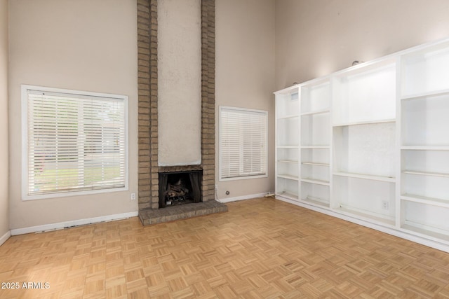966 E Driftwood Dr, Tempe, AZ 85283 - unfurnished living room featuring a high ceiling, baseboards, and a fireplace
