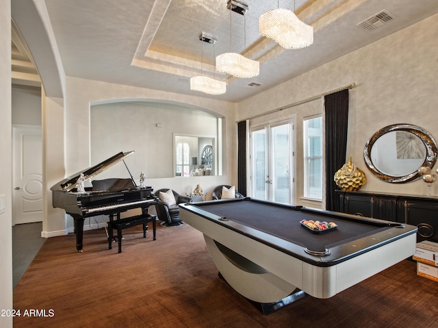 game room with a tray ceiling, pool table, and french doors