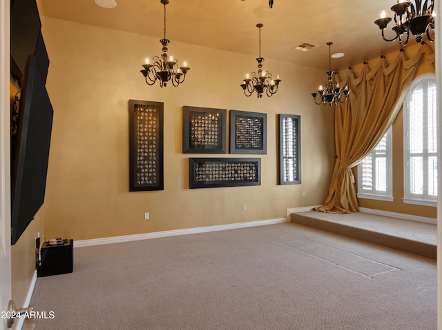 carpeted spare room featuring a chandelier