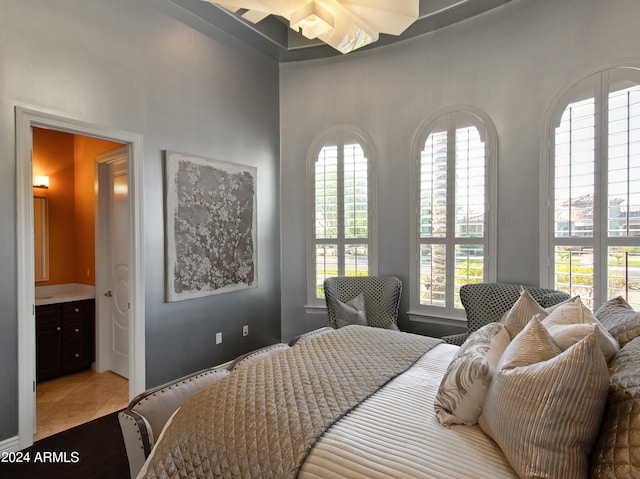 tiled bedroom featuring connected bathroom