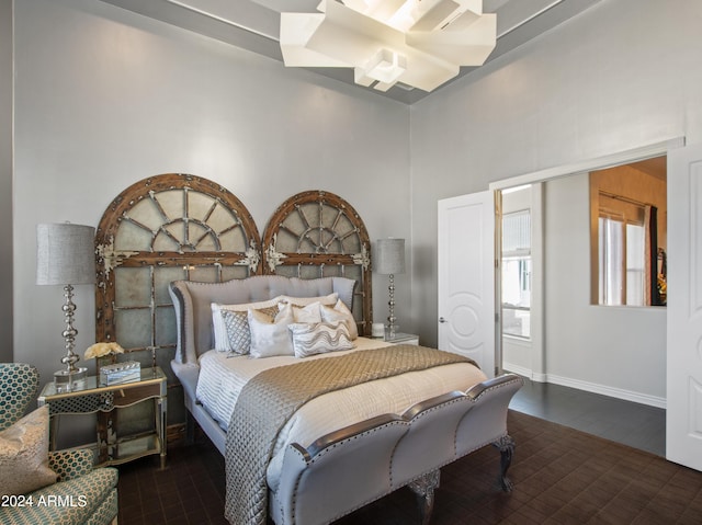 bedroom featuring a towering ceiling