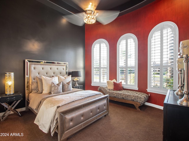 carpeted bedroom featuring multiple windows and ceiling fan