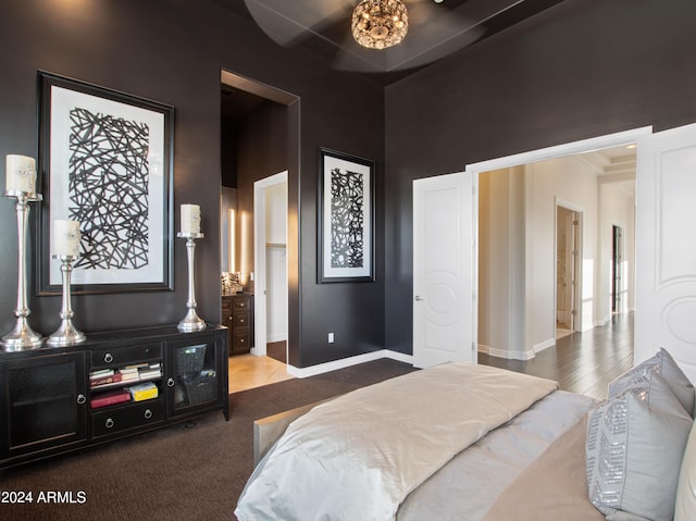 bedroom featuring carpet and a towering ceiling