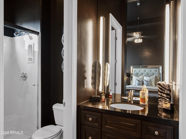 bathroom with vanity, toilet, and a shower with door