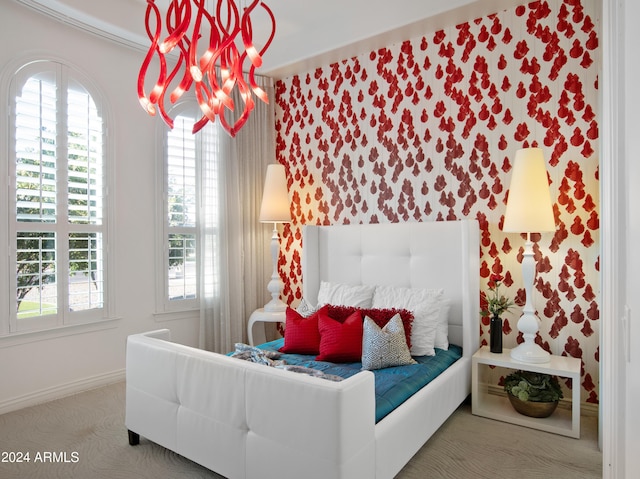 bedroom with carpet flooring, a chandelier, and multiple windows