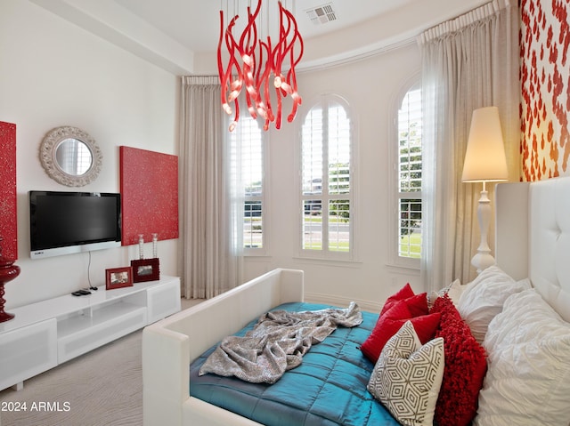 bedroom featuring carpet floors and a chandelier