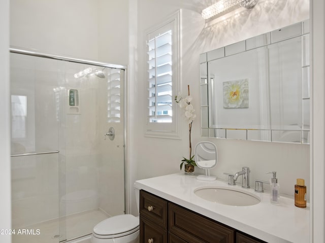 bathroom with vanity, toilet, and an enclosed shower