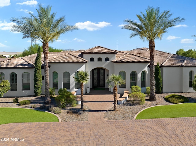 mediterranean / spanish-style home with french doors