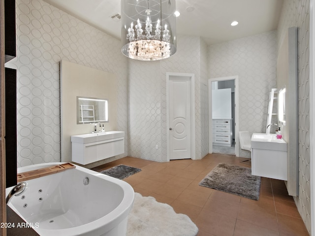 bathroom with vanity, a tub, and tile patterned floors