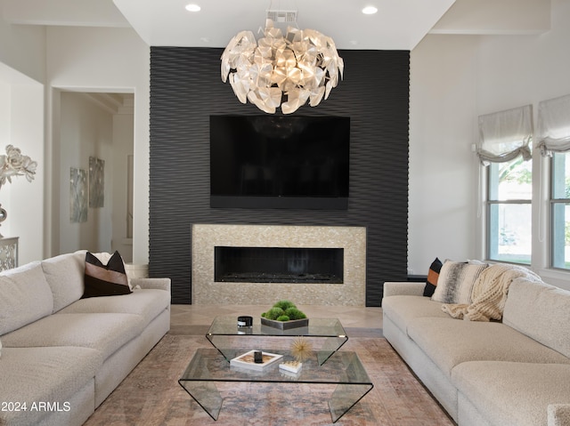 living room featuring an inviting chandelier and a fireplace