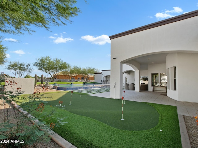 view of home's community with a pool and a patio