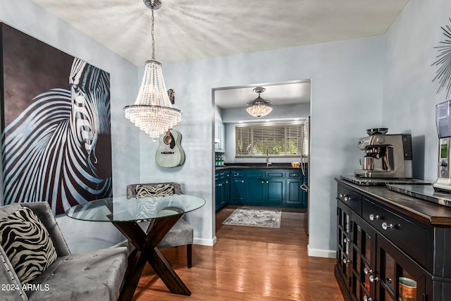 dining room featuring dark wood-type flooring and a chandelier