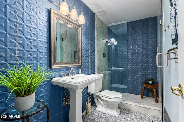 bathroom with toilet, tile patterned floors, tile walls, and a shower with door