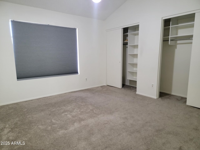 7801 N 44th Dr Unit 1036, Glendale, AZ 85301 - unfurnished bedroom featuring carpet floors, two closets, and vaulted ceiling