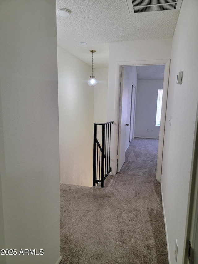 7801 N 44th Dr Unit 1036, Glendale, AZ 85301 - hall with an upstairs landing, carpet, and a textured ceiling
