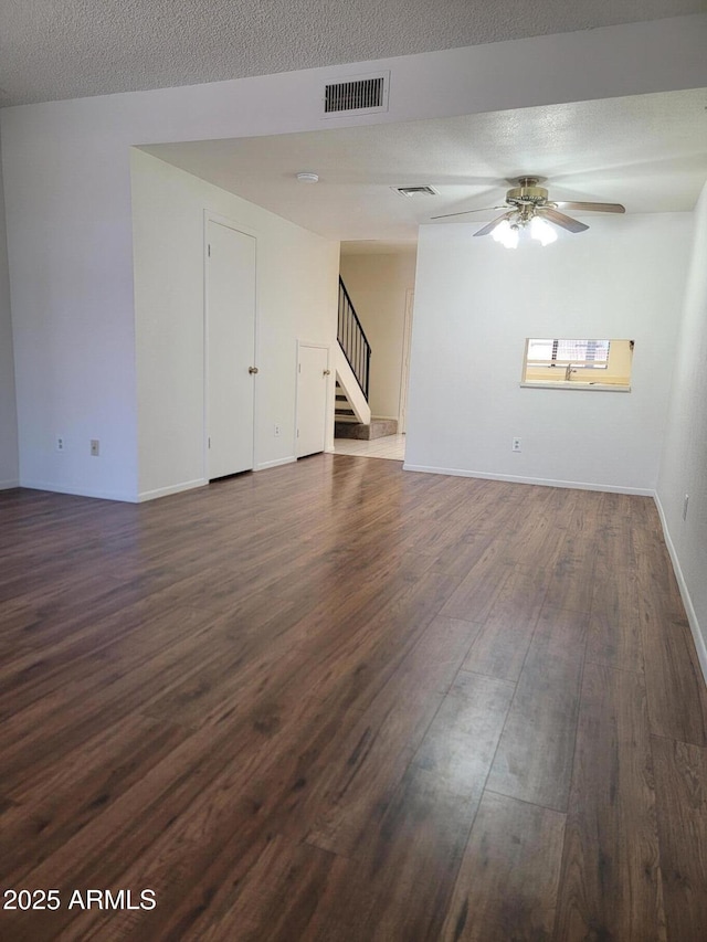 7801 N 44th Dr Unit 1036, Glendale, AZ 85301 - unfurnished living room featuring stairs, dark wood-style floors, a ceiling fan, and a textured ceiling