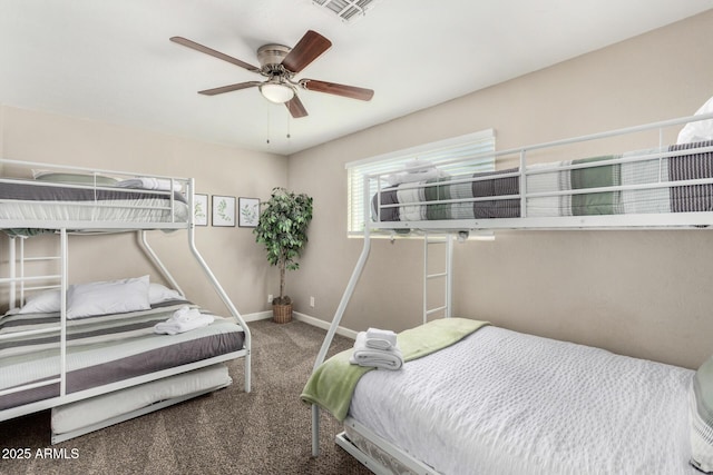 carpeted bedroom featuring ceiling fan, visible vents, and baseboards