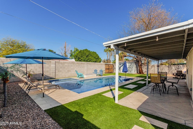 view of swimming pool featuring an outbuilding, a patio area, a fenced backyard, and a shed