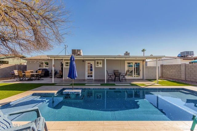 view of pool with a fenced in pool, french doors, fence, and a patio