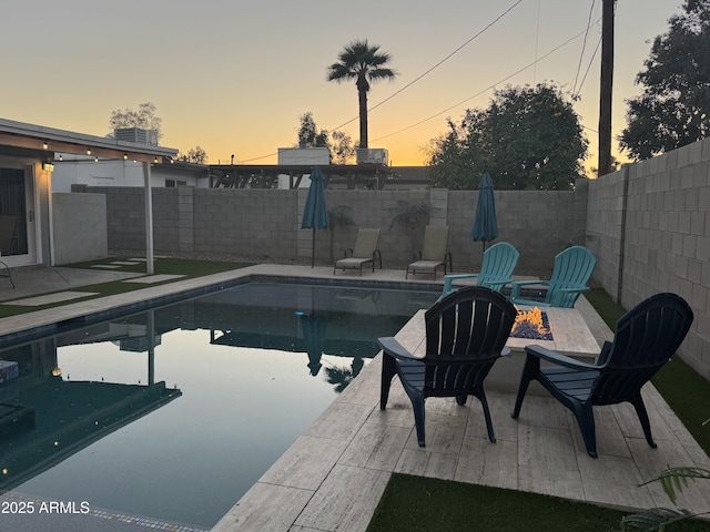 view of pool with a fenced in pool, an outdoor fire pit, a fenced backyard, and a patio