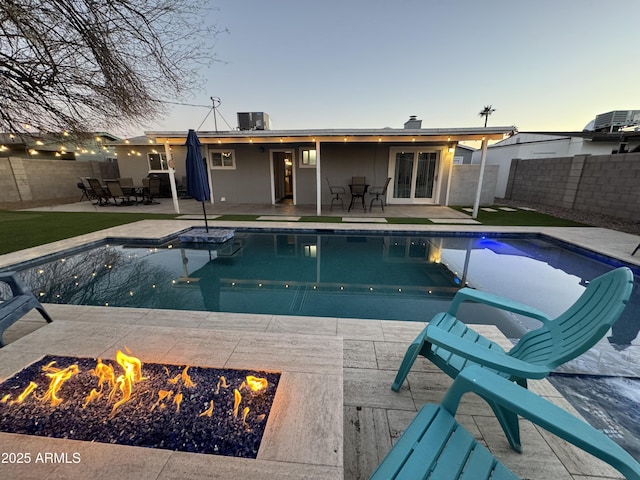 view of swimming pool featuring a fenced in pool, an outdoor fire pit, a patio area, and a fenced backyard