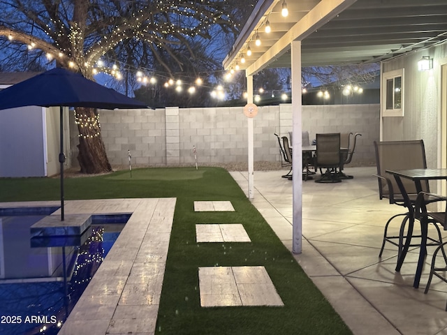 view of yard with a fenced in pool, outdoor dining area, a fenced backyard, and a patio